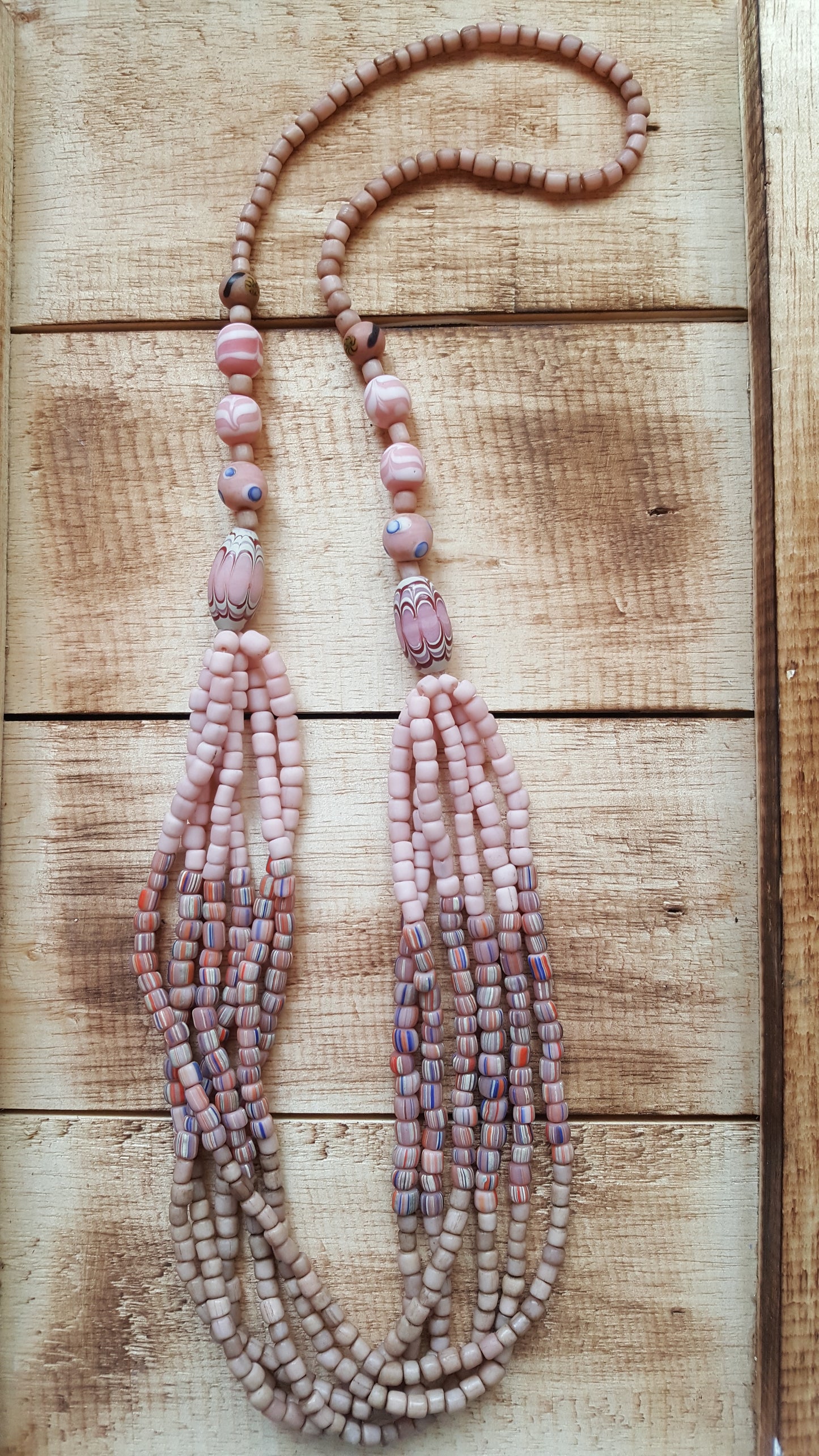 Cascading strands of glass, wood, and resin-cast beads with a slide system that adjusts from approximately 14-18 inches hanging length.  You will LOVE the layered design of this handcrafted multi-strand necklace, it never disappoints.  Go ahead, grab a few and wear them with everything!  You’ll be glad you did.